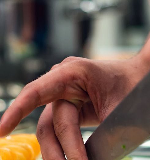 Kitchen Tools - Selective Focus Photo of Person Slicing Vegetable on Chopping Board