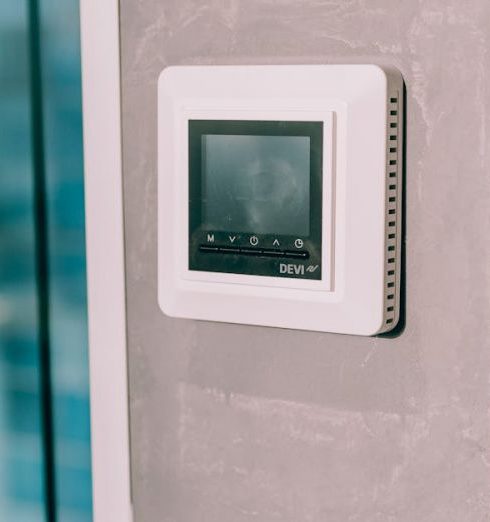 Smart Thermostat - A digital thermostat on a wall next to a window