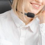 Voice Assistants - Smiling Woman Working in a Call Center