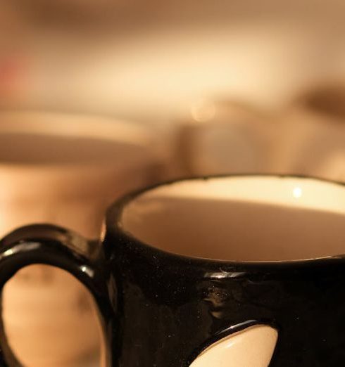 Color Scheme - A black ceramic coffee mug featuring a moon design, highlighted in warm lighting, perfect for cozy mornings.