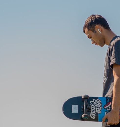 Smart Devices - Man Holding A Skateboard