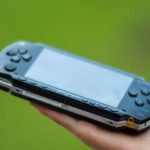 Outdoor Gadgets - Closeup Photography of Person Holding Black Sony Psp Handheld Console