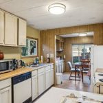 Countertops - Warm and functional kitchen interior with vintage oak cabinets and ample natural light.