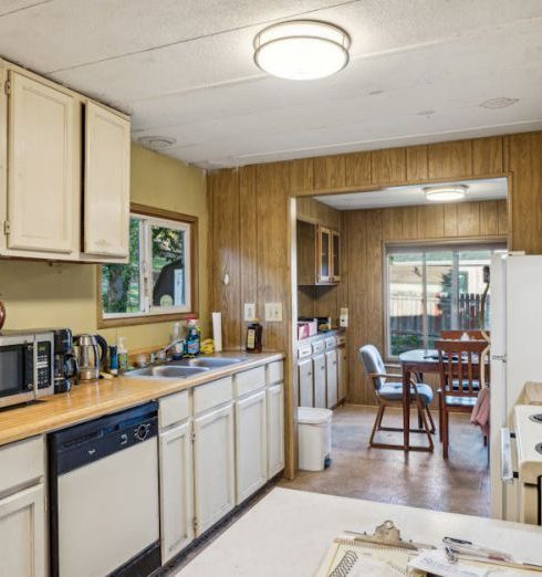 Countertops - Warm and functional kitchen interior with vintage oak cabinets and ample natural light.