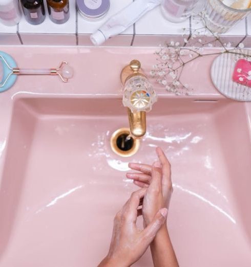 Under The Sink - Person Washing Hands on Pink Ceramic Sink