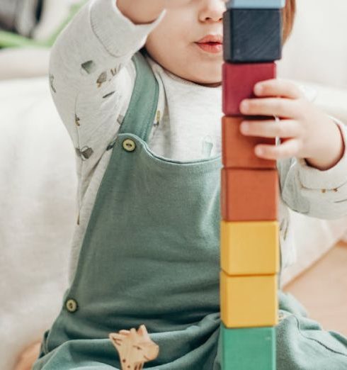 Playroom - Child in White Long-sleeve Top and Dungaree Trousers Playing With Lego Blocks