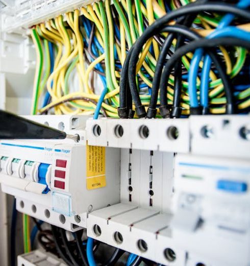 Cables - Electrician Fixing an Opened Switchboard