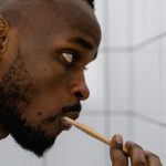 Tidy Bathroom - Close-up Photo of Man brushing his Teeth