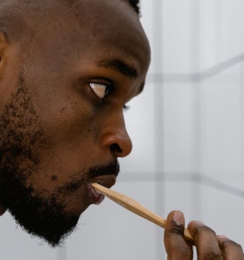 Tidy Bathroom - Close-up Photo of Man brushing his Teeth