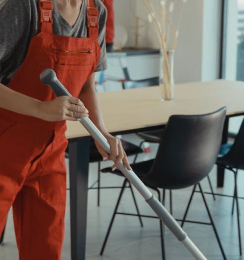 Cleaning Supplies - Woman Holding a Mop