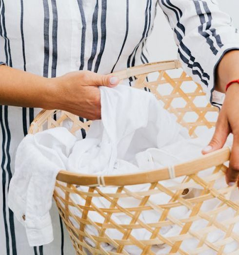 Laundry Sorting - Photo of a Person's Hands Holding a Basket