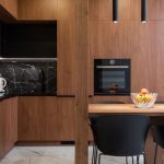 Black Accents - Wooden furniture and table in contemporary kitchen with dining zone