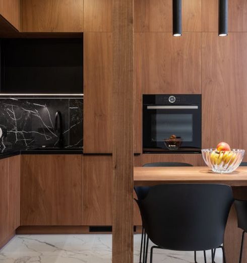 Black Accents - Wooden furniture and table in contemporary kitchen with dining zone