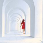 Natural Light - Woman in Red Dress Standing in White Arch Building