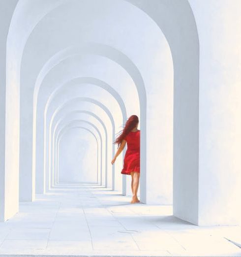 Natural Light - Woman in Red Dress Standing in White Arch Building