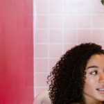 Bathroom Plants - Woman Talking on the Phone while Sitting in a Bathtub