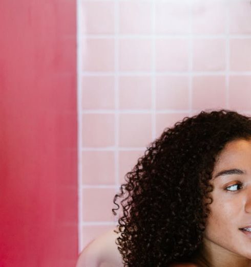 Bathroom Plants - Woman Talking on the Phone while Sitting in a Bathtub