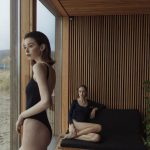 Coastal Bathroom - Woman in Black Tank Top and Black Shorts Sitting on Brown Wooden Bench