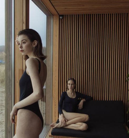 Coastal Bathroom - Woman in Black Tank Top and Black Shorts Sitting on Brown Wooden Bench