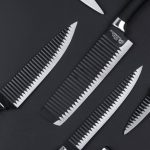 Tools - Top view of various kitchen utensils including knives scissors and vegetable peeler on black background