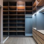 Closet Space - Interior of modern spacious wardrobe room with empty shelves near door and mirror