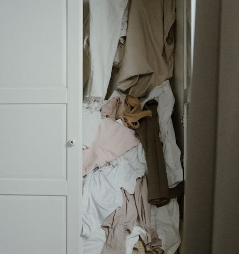 Linen Closet - Photo of an Untidy and Messy White Wooden Closet