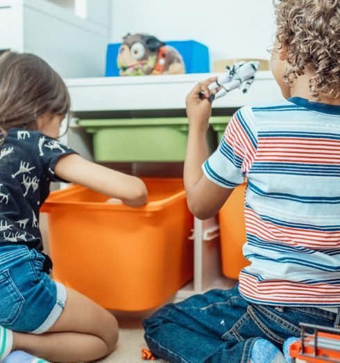 Toy Storage - 2 Children Sitting on Orange Chair