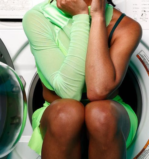 Laundry Room - Fashion Model sitting in a washing machine