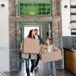 Entryway Storage - A Mother and Child Carrying Cardboard Boxes into the Kitchen Area