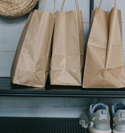 Shoe Storage - Brown Shopping Bags on Metal Rack