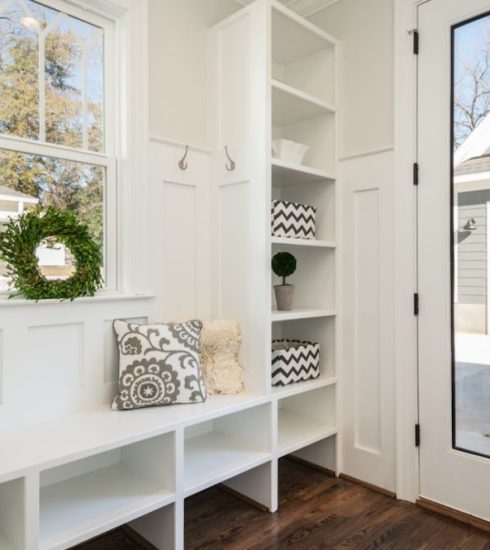 Mudroom - gray and white floral throw pillow beside rack inside room