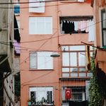 Shabby Chic - Urban alleyway with colorful buildings and laundry hanging outside in a city setting.