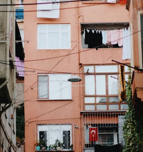 Shabby Chic - Urban alleyway with colorful buildings and laundry hanging outside in a city setting.