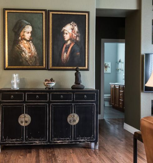 Retro Furniture - Black Wooden Cabinet Under Two Women Paintings