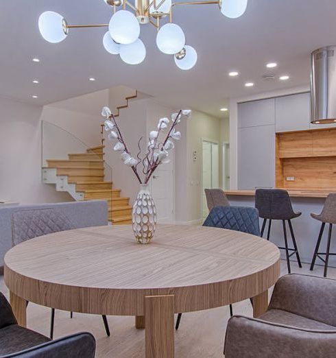 Lighting - Round Brown Wooden Table With Chairs Inside Room