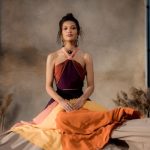 Ornamental Grasses - A Woman in Halter Dress Sitting on the Textile Beside the Wheat Grass