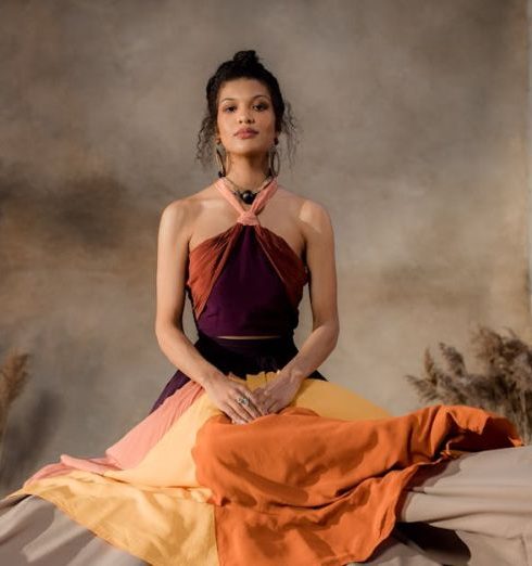 Ornamental Grasses - A Woman in Halter Dress Sitting on the Textile Beside the Wheat Grass