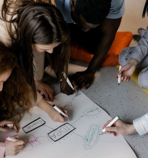 Target Audience - A diverse team of young adults collaborating on a startup project with brainstorming sketches.