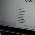 Online Presence - A close-up shot of a laptop displaying a Google search page with related searches visible.