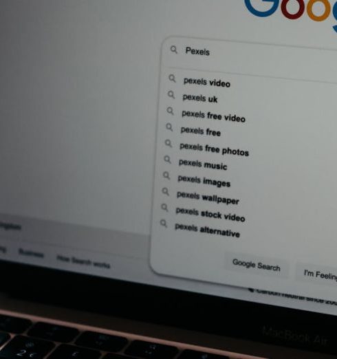 Online Presence - A close-up shot of a laptop displaying a Google search page with related searches visible.