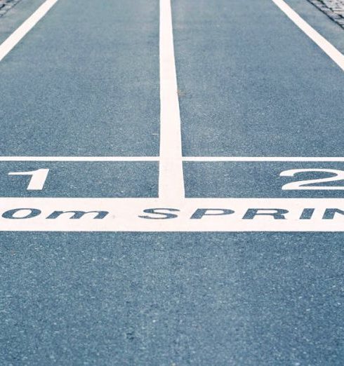 Goals - Close-up of outdoor 100m sprint track lanes, perfect for athletics and sprinting events.