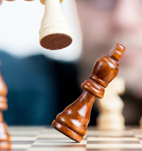 Competition - Close-up of a chess game with a focused player, emphasizing strategy and competition.