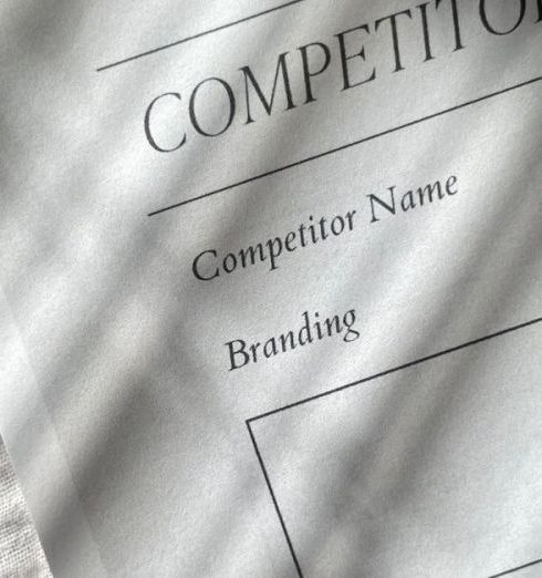 Competitor Analysis - A competitor analysis sheet with stylish shadows on a textured fabric background, conveying a professional tone.