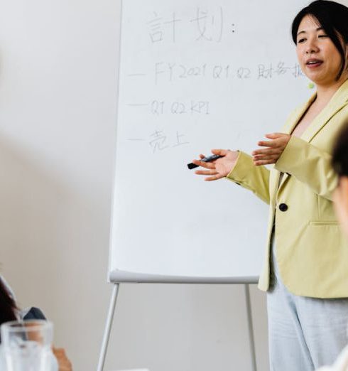 KPIs - Confident businesswoman presenting strategy to colleagues in a modern office setting.