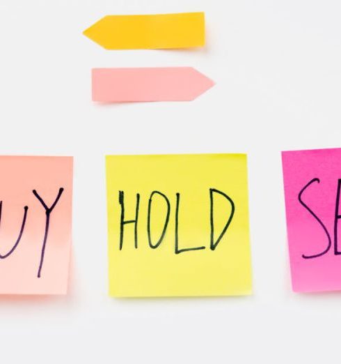 Investment Opportunities - Colorful sticky notes with financial terms 'Buy', 'Hold', and 'Sell' on a clean white backdrop.