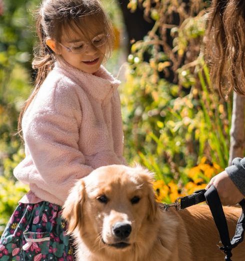 Companion Plants - A loving moment between a mother, daughter, and their golden retriever on a sunny sidewalk in Québec.