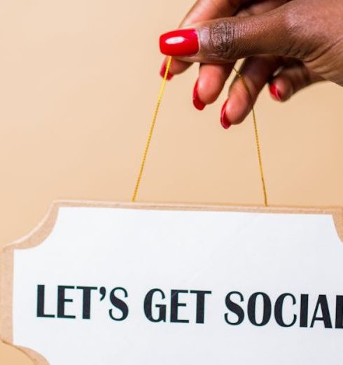 Brand Story - A hand holding a "Let's Get Social" sign, ideal for marketing and social media themes.