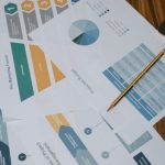 Marketing Funnel - Overhead view of project management documents and charts on a desk with a pencil.