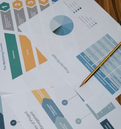 Marketing Funnel - Overhead view of project management documents and charts on a desk with a pencil.