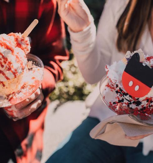 User-Generated Content - Two people enjoying vibrant ice cream sundaes outdoors on a sunny day.